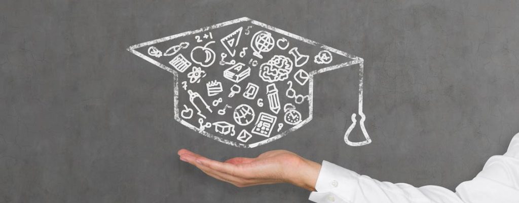 A hand holding a graduation hat